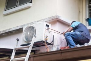 Technician installing an outdoor air conditioning unit