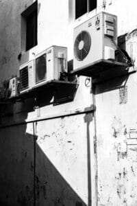 Outdoor wall-mounted air conditioning and heat pump units on a building exterior in Ontario.