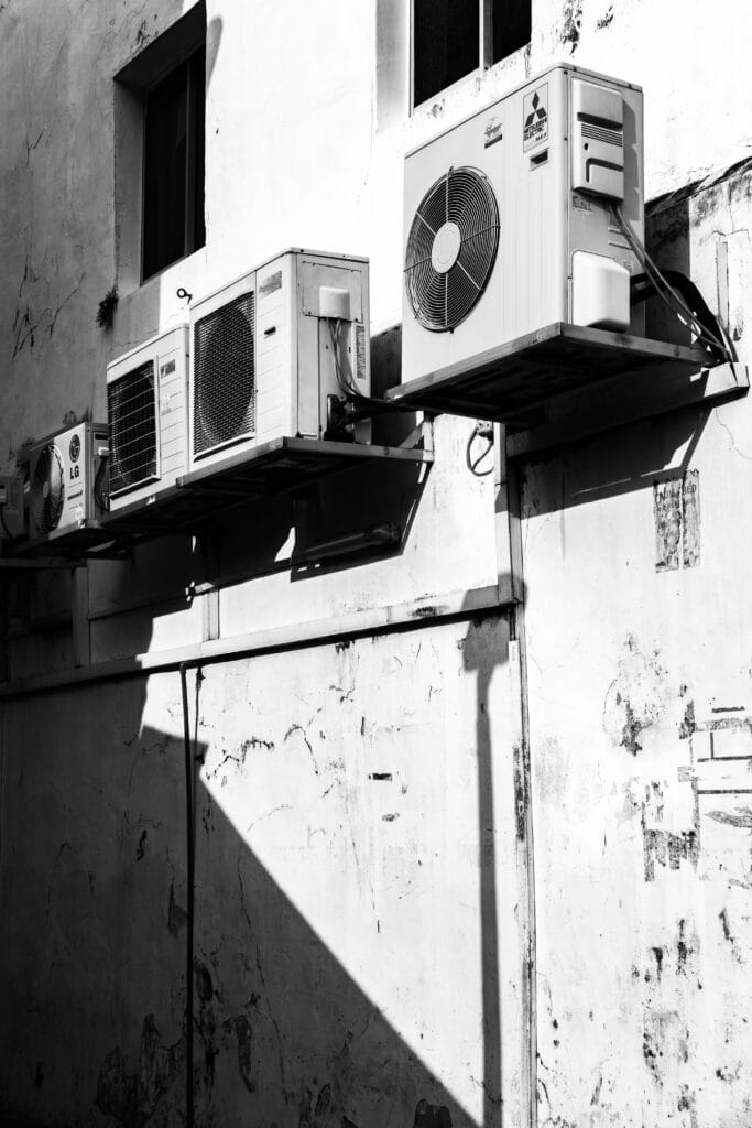 Outdoor wall-mounted air conditioning and heat pump units on a building exterior in Ontario.
