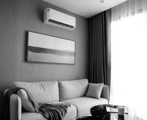 Wall mounted mini split head with outdoor unit on a raised stand at a Durham Region home.