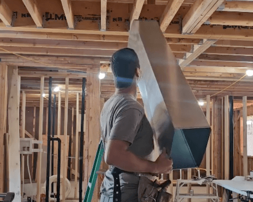 HVAC Zack installing a supply trunk during a new build in Durham Region.