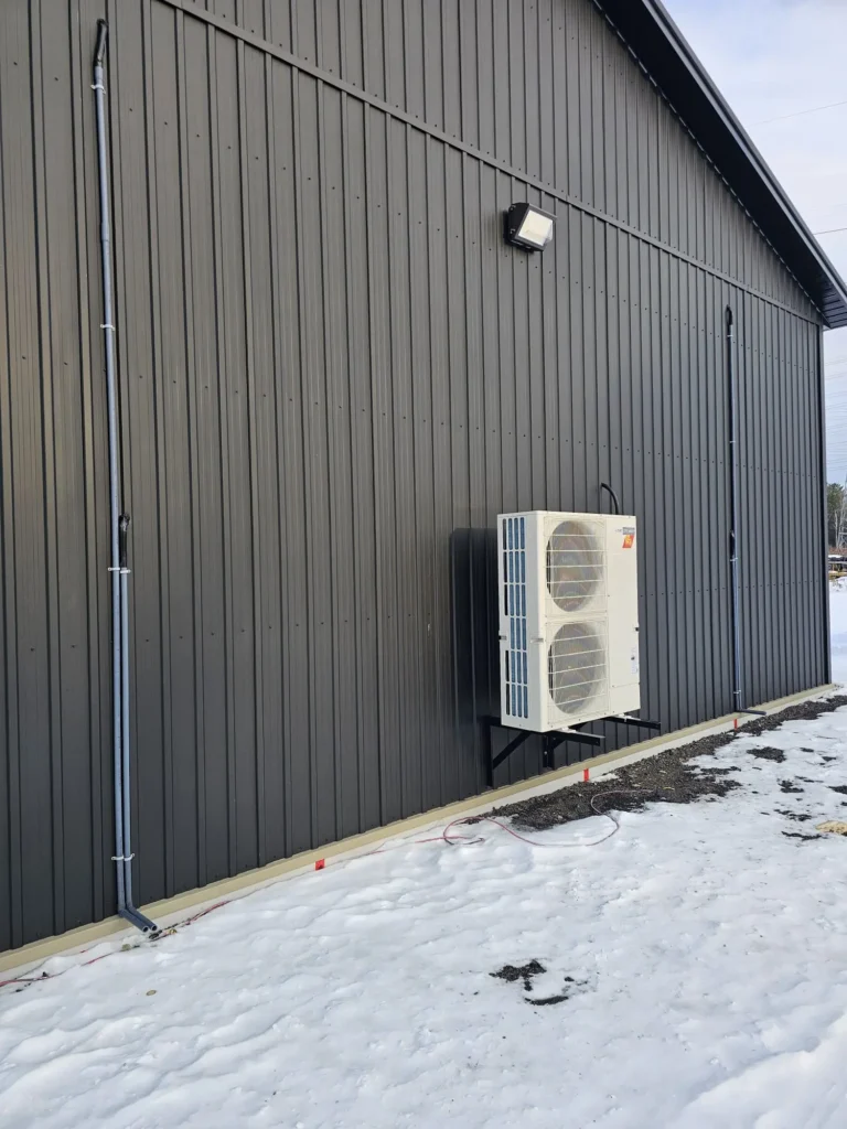 Commercial Mitsubishi heat pump installed on shop building in North Whitby