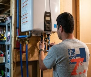 HVAC Zack putting the finishing touches on the installation of a Navien tankless water heater