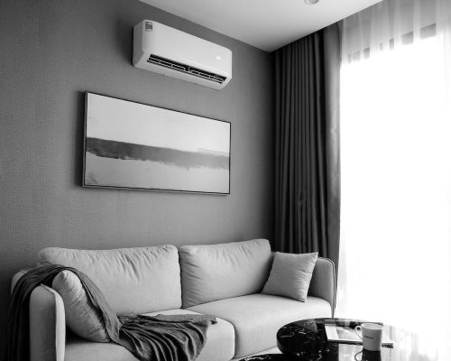mini-split-heat-pump-installation-durham-region Wall mounted mini split head with outdoor unit on a raised stand at a Durham Region home.