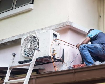 Technician installing an outdoor air conditioning unit